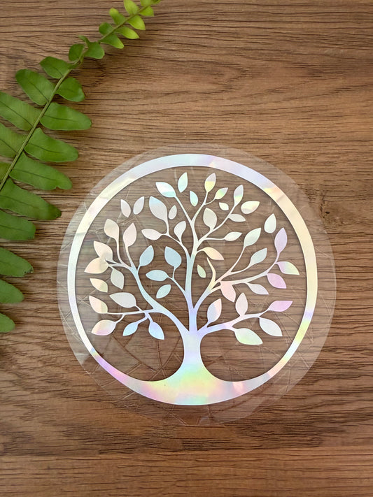 Tree of Life rainbow window cling creating colorful prism reflections on a sunny window.