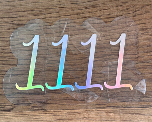 1111 angel number rainbow window cling creating colorful light reflections on a window