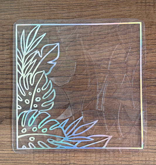 Tropical leaf corner rainbow window cling creating colorful prism reflections on a sunny window